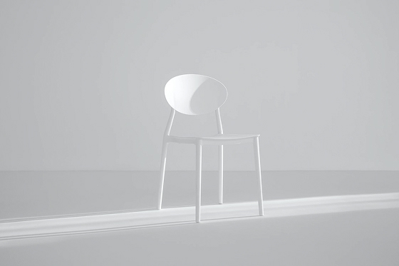 a stool white chair in bright light